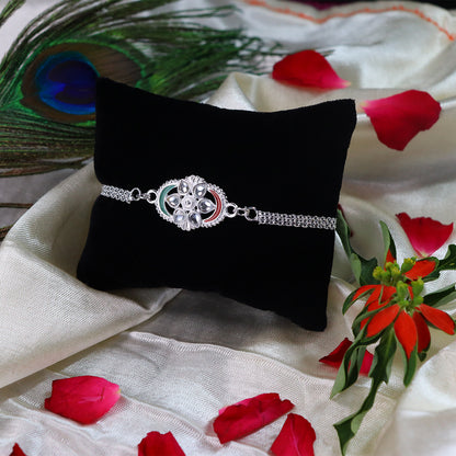 Silver Chain Rakhi With Sparkling Stones And Elegant Red-green Detailing