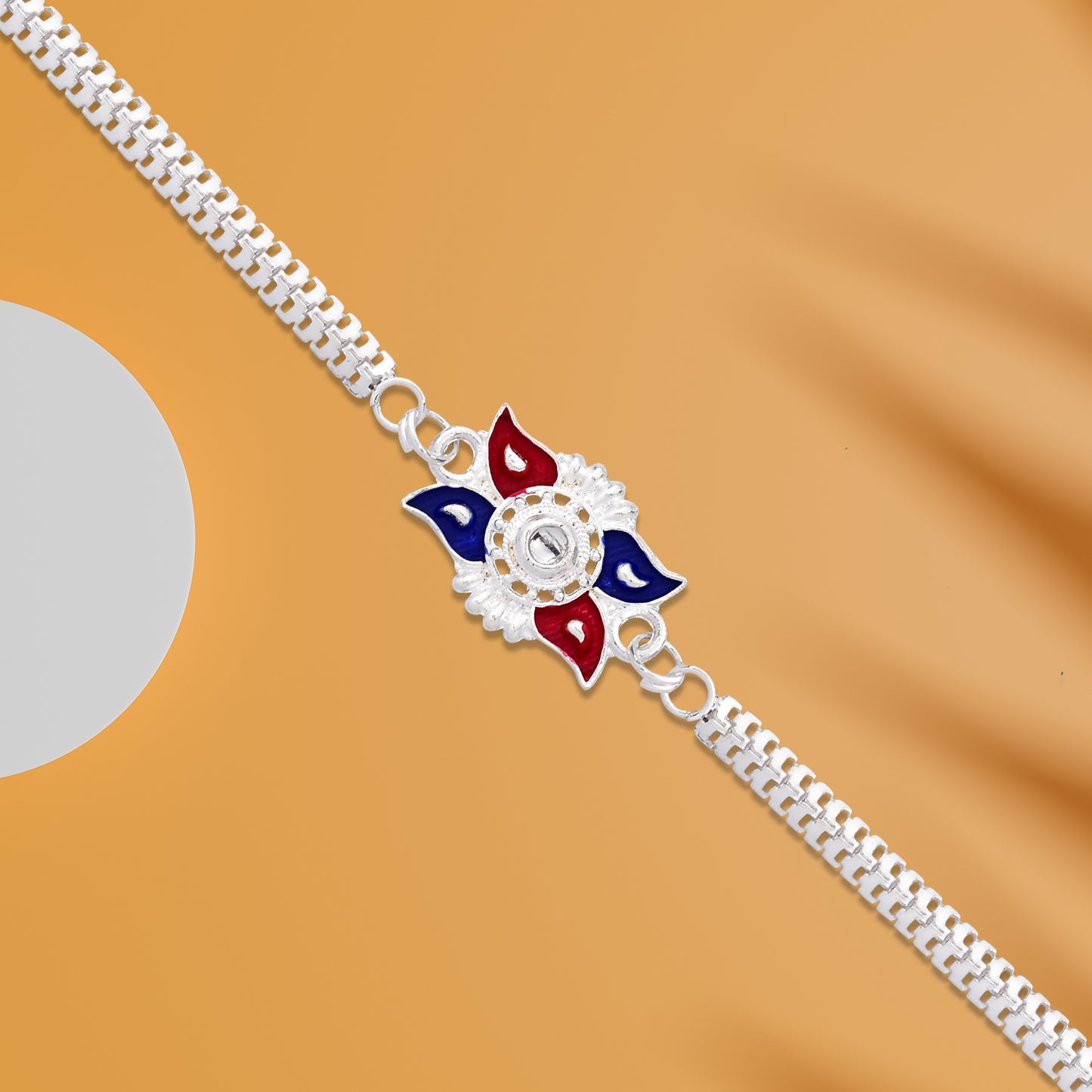 Stylish Sun Design Rakhi With Red-blue Enamel And Silver-tone Metal Chain