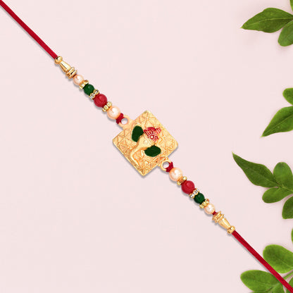 Golden Ganpati Rakhi With Red-green Beads And Enamel Detailing