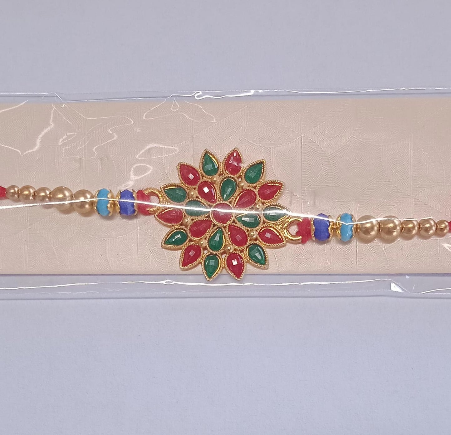 Red And Green Colored Stone Flower Design Rakhi