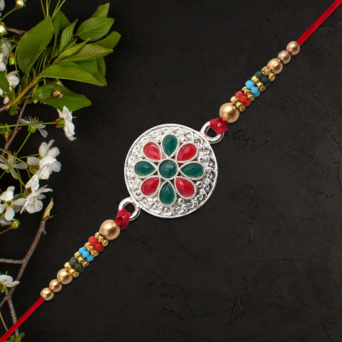 Silver Plated Floral Rakhi With Red  Green Stones