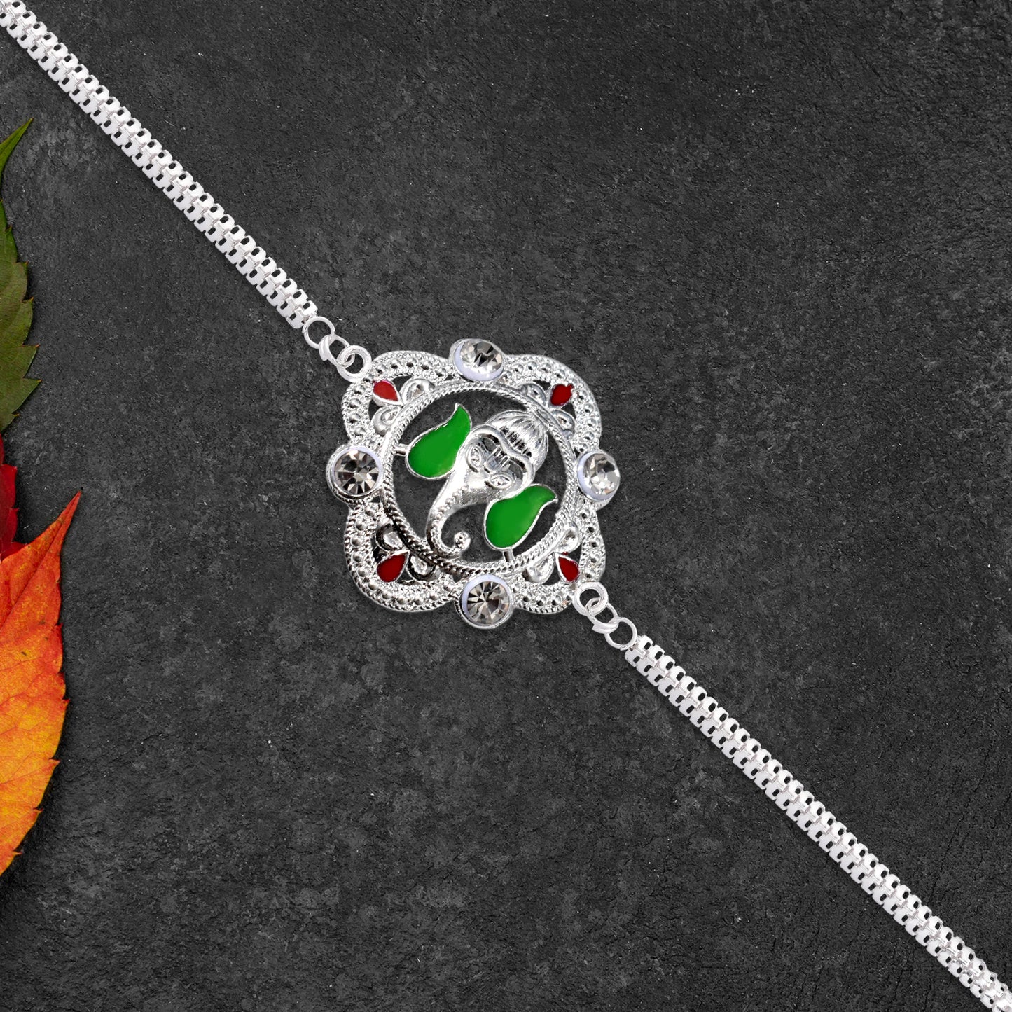 Silver Ganesha Rakhi With Green Leaf Accent